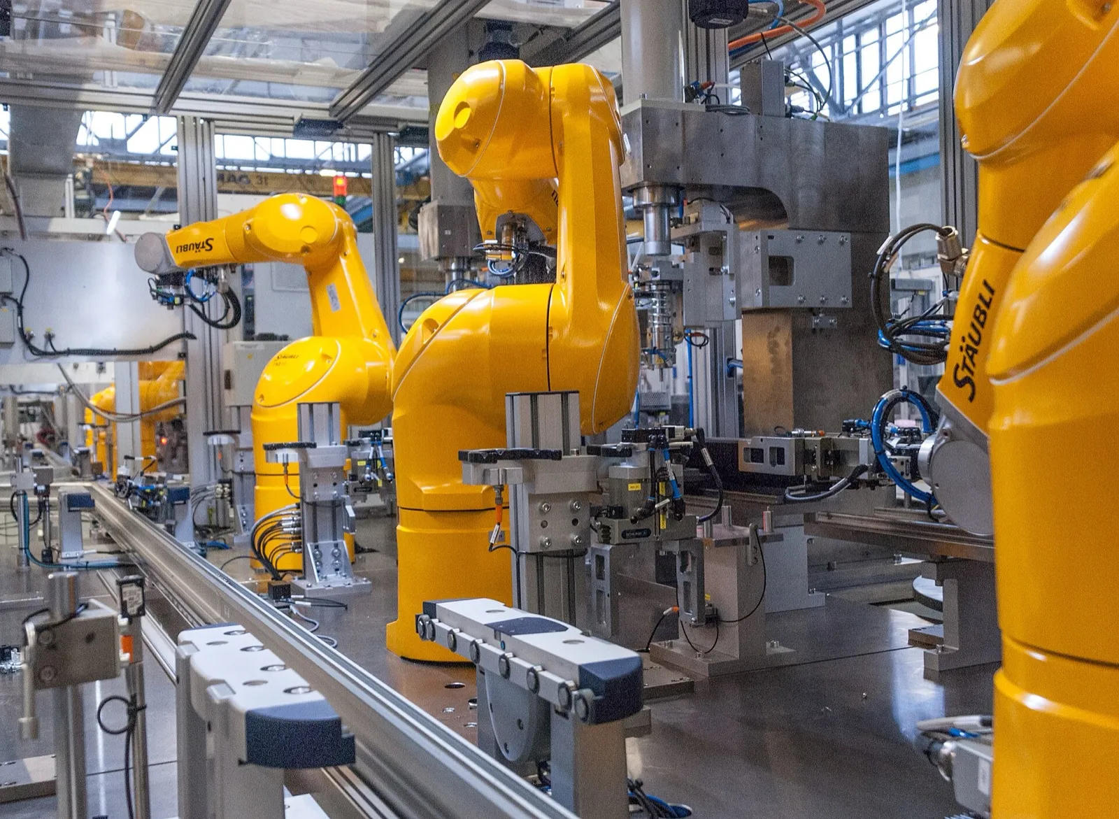 Industrial robot arms working along an assembly line