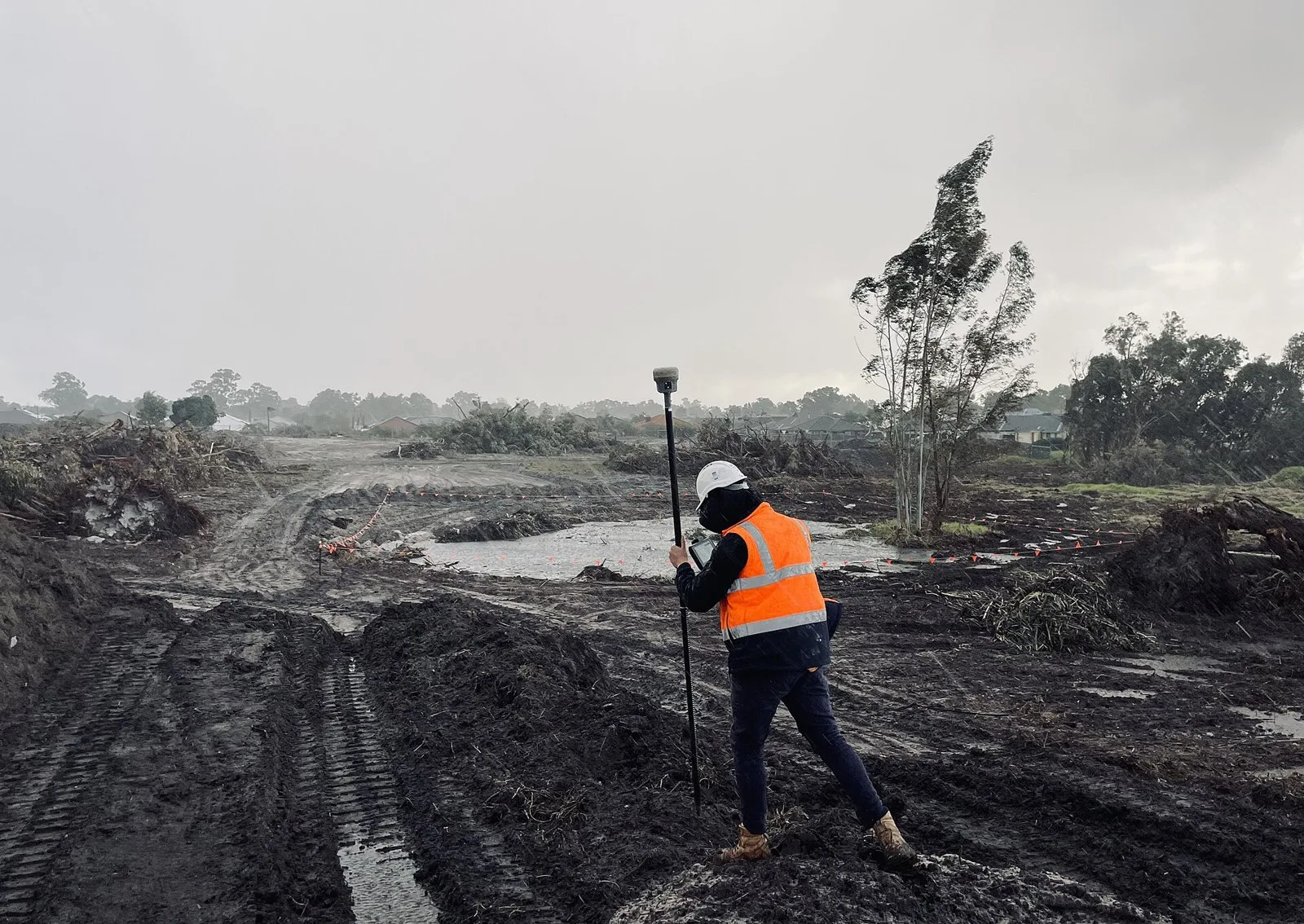 A surveyor with a GNSS rover on a construction site