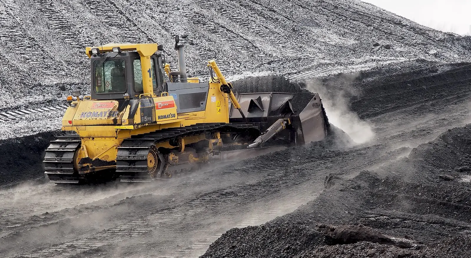A bulldozer pushing coal on a stockpile at a power plant
