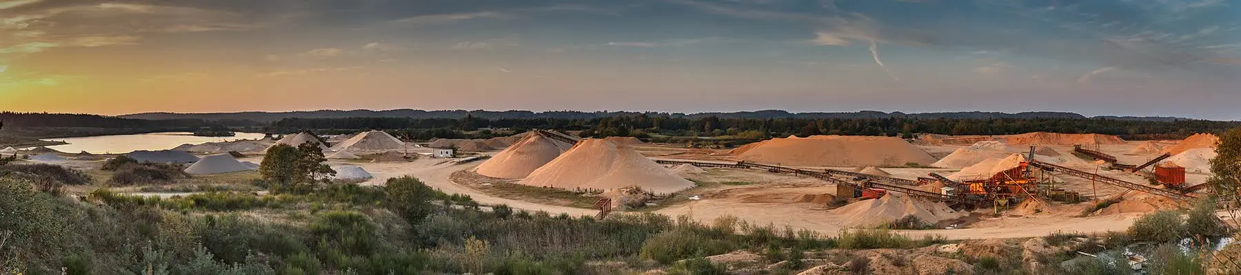 A wide view of a gravel pit with its processing plant and stockpiles